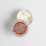 Open tin of King Brown Pomade's Cream Pomade, displaying the smooth white texture of the cream. With a low hold, and medium shine, this cream provides a light consistency that allows easy application and is great for a natural look, textured styles and thinner hair. 